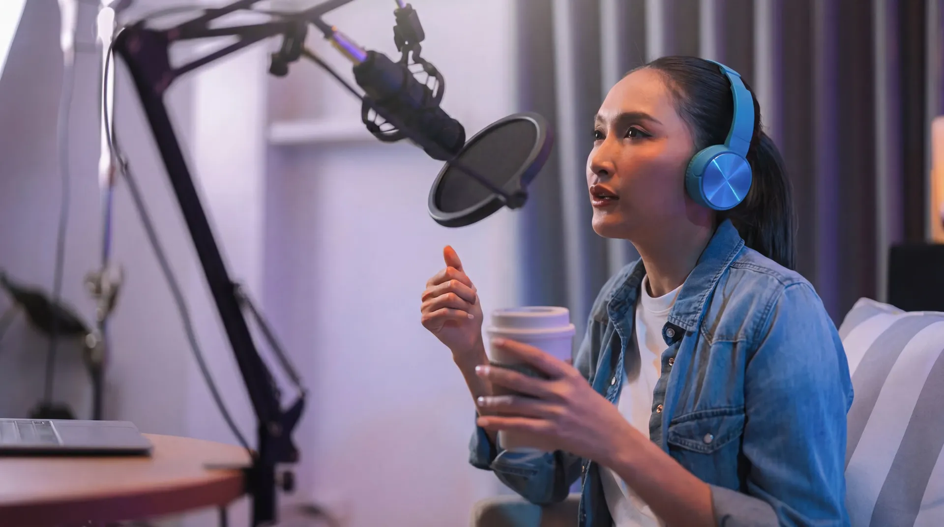 Woman speaking into studio microphone