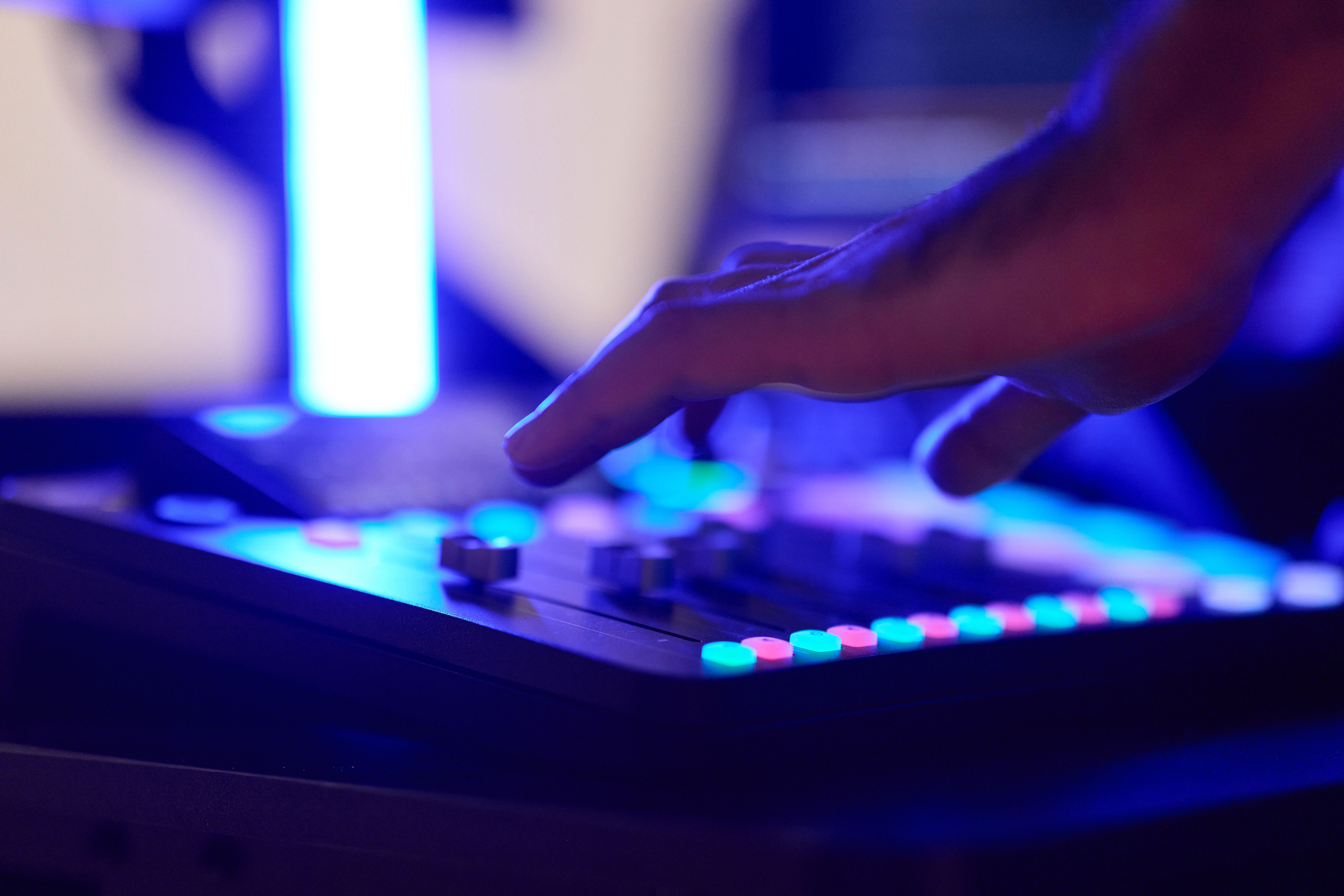 A close up of a producer working with sound console